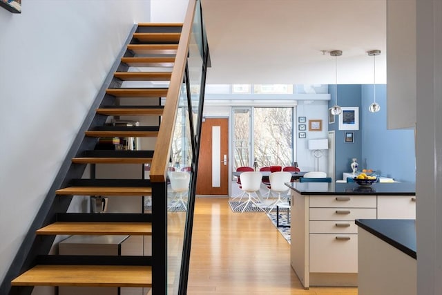 staircase with hardwood / wood-style flooring