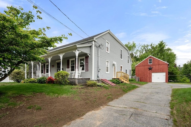 19 E St, Grafton, MA 01536 - view of front facade featuring an outdoor structure, a garage, covered porch, and driveway