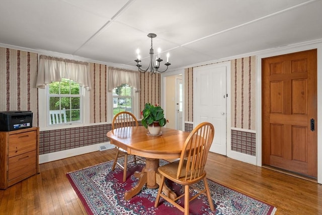 19 E St, Grafton, MA 01536 - dining space featuring wallpapered walls, a chandelier, crown molding, and hardwood / wood-style floors
