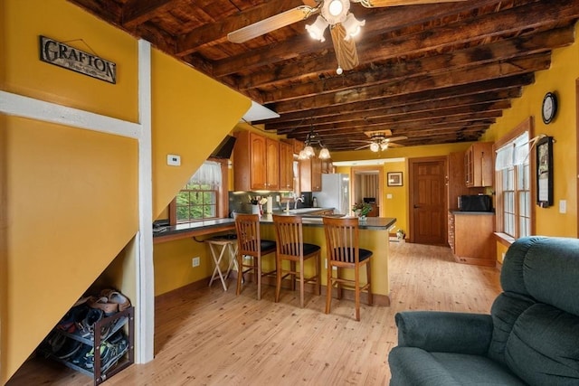 19 E St, Grafton, MA 01536 - kitchen with a ceiling fan, open floor plan, a peninsula, freestanding refrigerator, and light wood finished floors