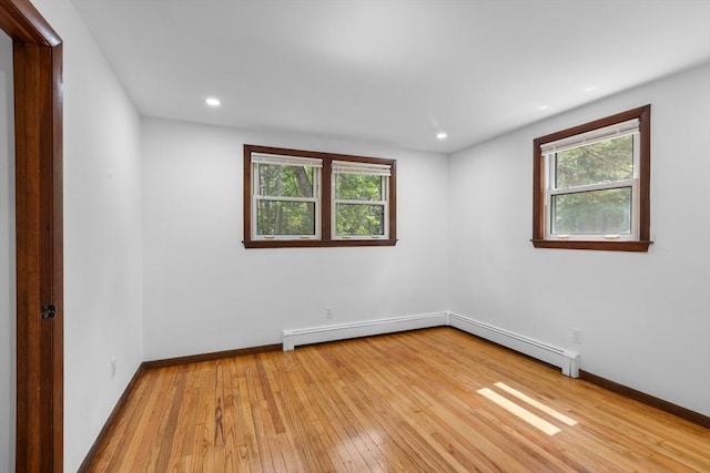 268 Pine St, Tewksbury, MA 01876 - empty room with light wood-style flooring, healthy amount of natural light, a baseboard radiator, and recessed lighting