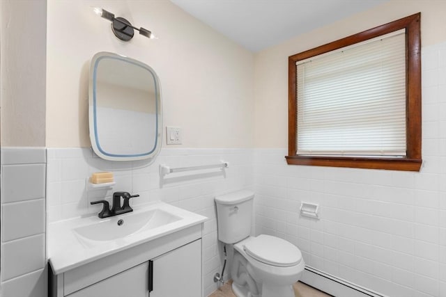 268 Pine St, Tewksbury, MA 01876 - half bathroom with baseboard heating, tile walls, vanity, and a wainscoted wall