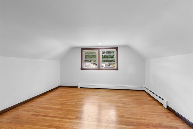 268 Pine St, Tewksbury, MA 01876 - additional living space with a baseboard radiator, vaulted ceiling, and wood finished floors