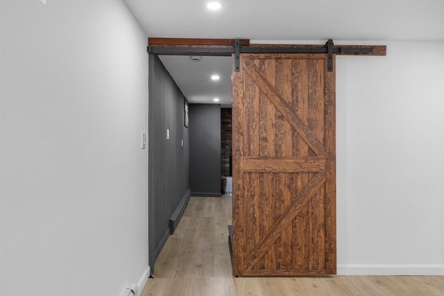 268 Pine St, Tewksbury, MA 01876 - hallway with light wood-style floors, a barn door, a baseboard heating unit, and recessed lighting