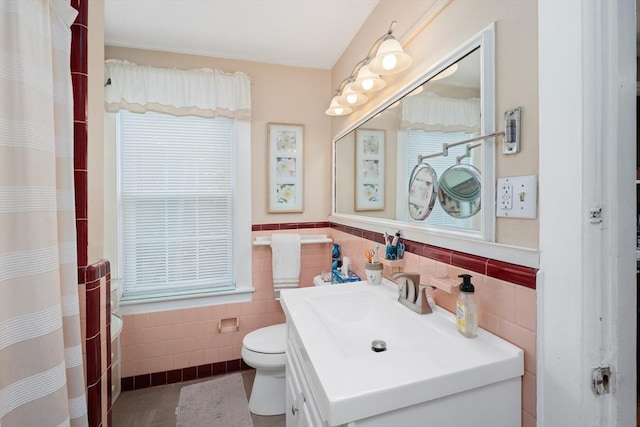 85 Everett St, Southbridge, MA 01550 - full bath with tile walls, toilet, vanity, a wainscoted wall, and a shower with shower curtain
