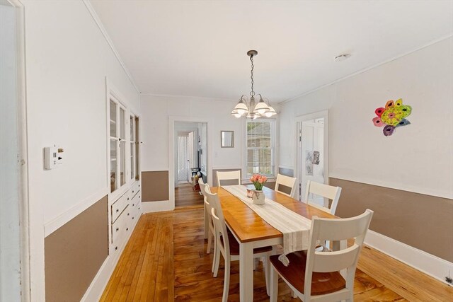 85 Everett St, Southbridge, MA 01550 - dining area with light wood-style floors, a chandelier, ornamental molding, and baseboards