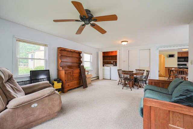 26 Presidents Rd, Weymouth, MA 02188 - living area featuring independent washer and dryer, ceiling fan, plenty of natural light, and light carpet