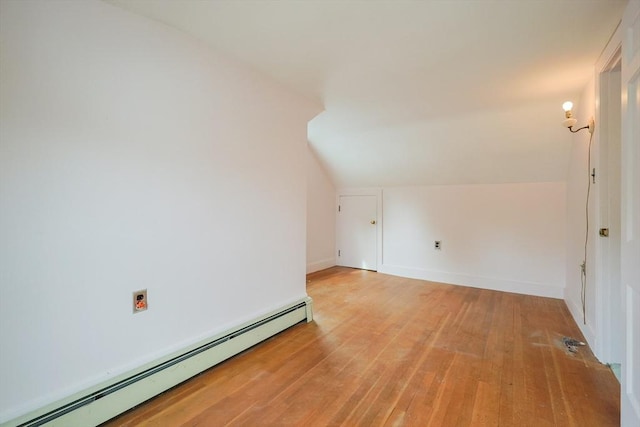 26 Presidents Rd, Weymouth, MA 02188 - additional living space with a baseboard heating unit, vaulted ceiling, light wood-style floors, and baseboards