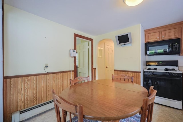 26 Presidents Rd, Weymouth, MA 02188 - dining area featuring baseboard heating, a wainscoted wall, arched walkways, and wood walls