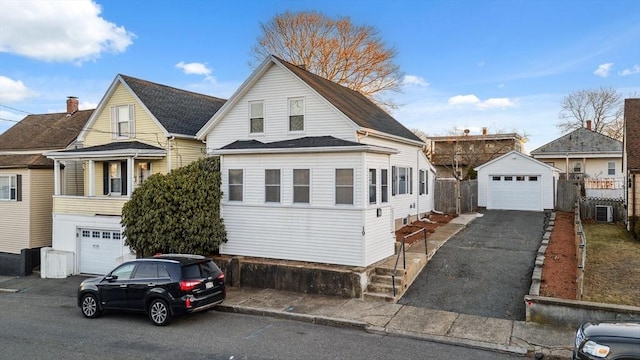 view of front of home featuring central air condition unit, an outbuilding, and a garage