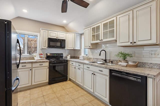 kitchen featuring sink, vaulted ceiling, light tile patterned flooring, ceiling fan, and black appliances