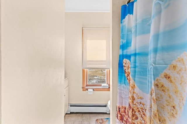 bathroom with a baseboard heating unit and toilet