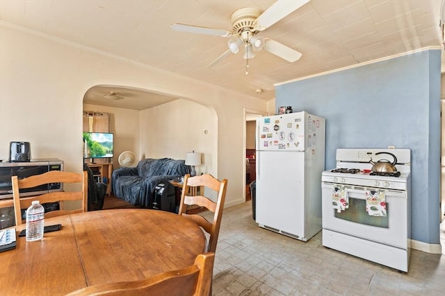 dining room with arched walkways, ceiling fan, and light floors