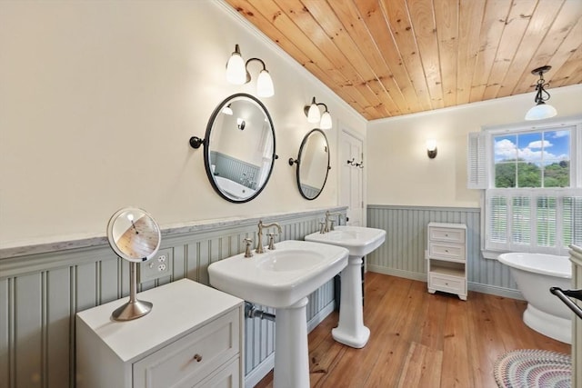 39 Cook Rd, Southampton, MA 01073 - full bathroom with wainscoting, wood-type flooring, a freestanding tub, wooden ceiling, and crown molding
