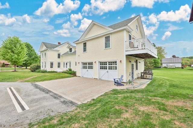 39 Cook Rd, Southampton, MA 01073 - back of property featuring a garage, a yard, and decorative driveway