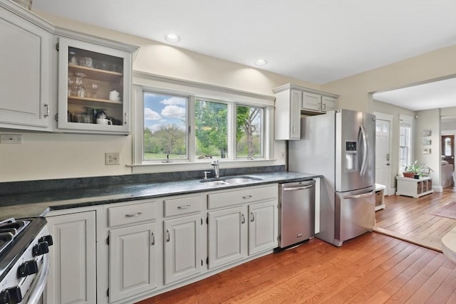 39 Cook Rd, Southampton, MA 01073 - kitchen with appliances with stainless steel finishes, a sink, dark countertops, and glass insert cabinets