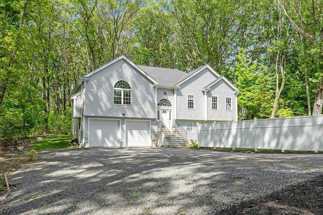 136 Ararat St, Worcester, MA 01606 - view of front of home with driveway, a garage, and view of scattered trees