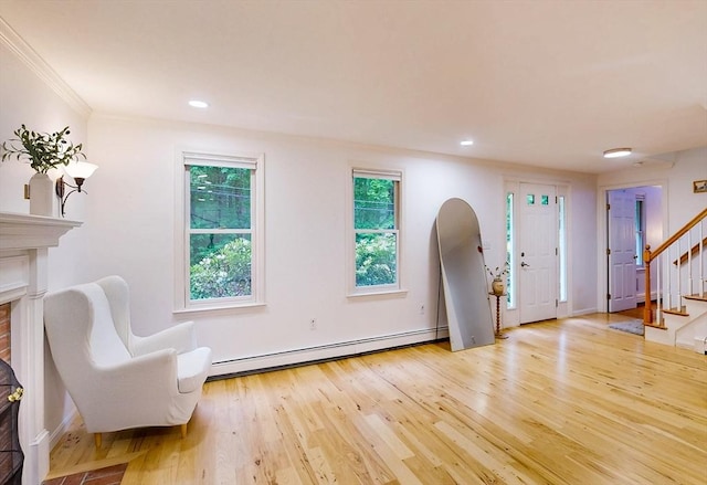 79 Charter Rd, Acton, MA 01720 - foyer entrance with a baseboard heating unit, stairway, light wood-style flooring, a brick fireplace, and recessed lighting