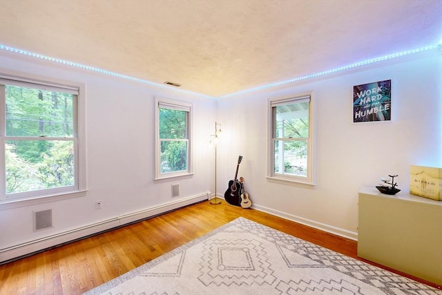 79 Charter Rd, Acton, MA 01720 - empty room featuring a baseboard radiator, wood finished floors, and baseboards