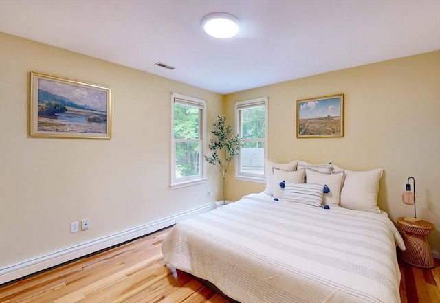 79 Charter Rd, Acton, MA 01720 - bedroom featuring wood finished floors, a baseboard heating unit, and baseboards