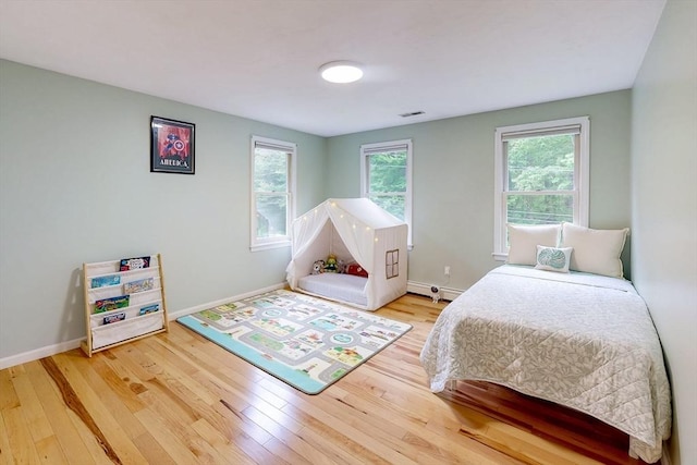 79 Charter Rd, Acton, MA 01720 - bedroom featuring wood finished floors, multiple windows, and baseboards