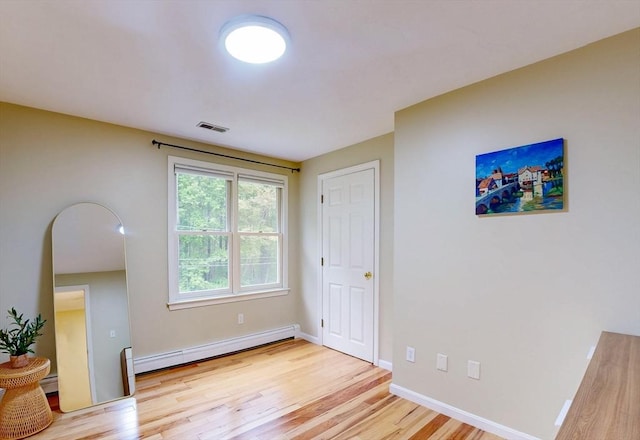 79 Charter Rd, Acton, MA 01720 - empty room featuring baseboard heating, light wood-style floors, and baseboards