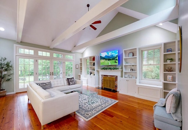 79 Charter Rd, Acton, MA 01720 - living room with beamed ceiling, ceiling fan, wood finished floors, a fireplace with flush hearth, and plenty of natural light