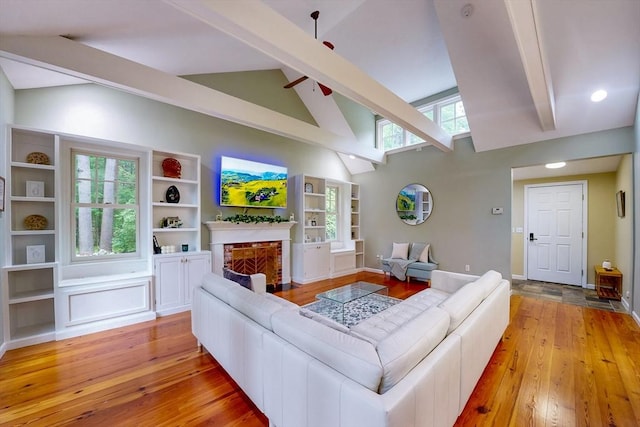 79 Charter Rd, Acton, MA 01720 - living area featuring beam ceiling, light wood-type flooring, high vaulted ceiling, a fireplace with flush hearth, and ceiling fan