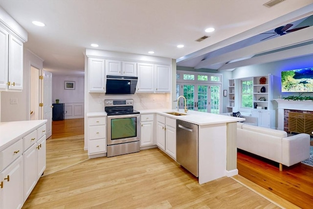 79 Charter Rd, Acton, MA 01720 - kitchen featuring appliances with stainless steel finishes, a sink, a peninsula, white cabinetry, and recessed lighting