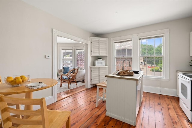 148-150 Pleasant St Unit 2, Marblehead, MA 01945 - kitchen with white appliances, a sink, light wood finished floors, and plenty of natural light