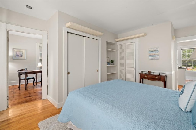 148-150 Pleasant St Unit 2, Marblehead, MA 01945 - bedroom with light wood finished floors, baseboards, and multiple closets