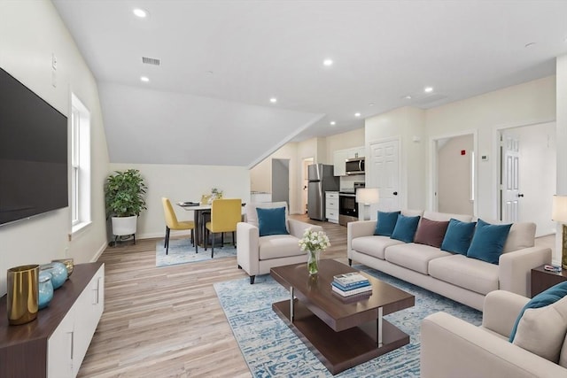 living room featuring lofted ceiling, recessed lighting, visible vents, baseboards, and light wood-style floors