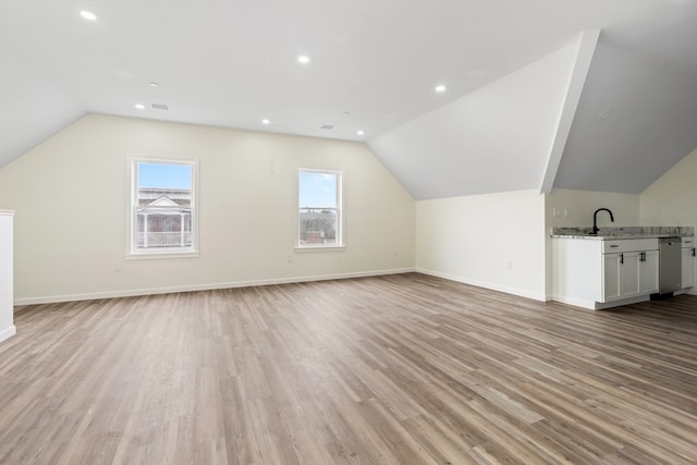 additional living space featuring light wood-style floors, recessed lighting, vaulted ceiling, and baseboards