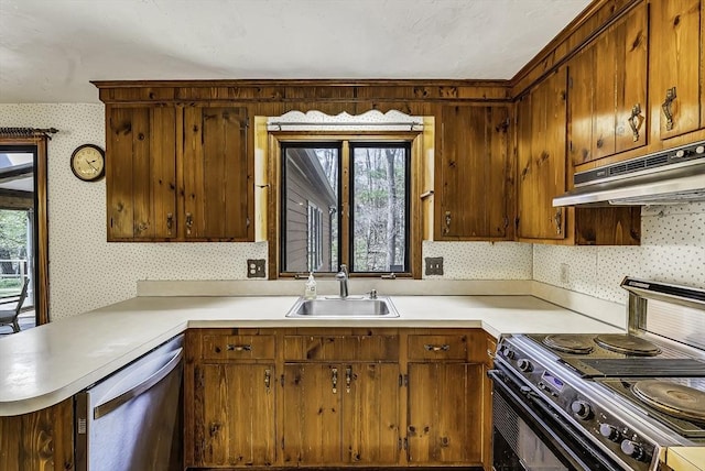 kitchen with a sink, black electric range oven, under cabinet range hood, and wallpapered walls