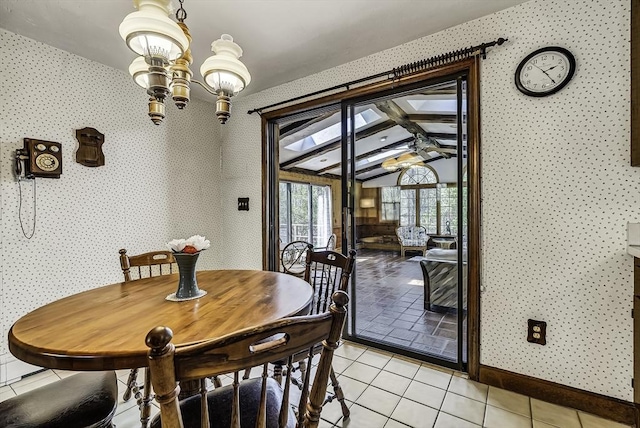 dining space featuring an inviting chandelier, light tile patterned floors, and wallpapered walls