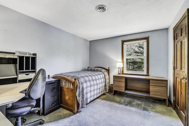bedroom featuring dark carpet and visible vents