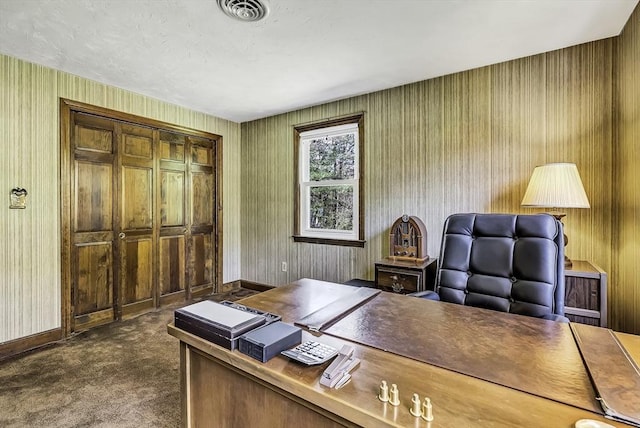 office featuring visible vents, baseboards, and dark colored carpet