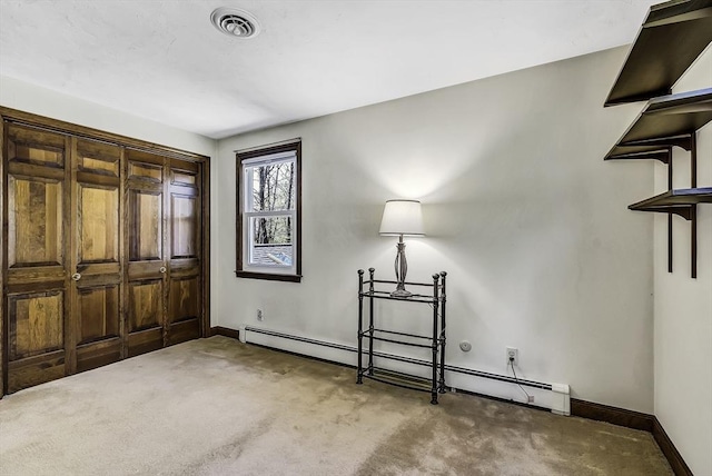 entryway featuring baseboards, carpet flooring, baseboard heating, and visible vents