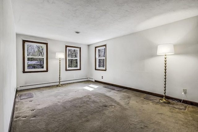 carpeted spare room with baseboards and a baseboard radiator