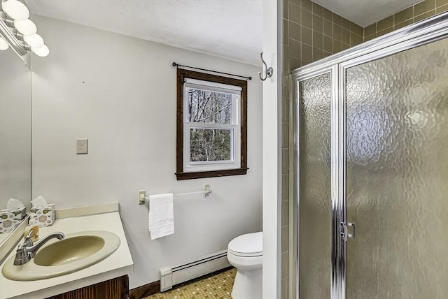 bathroom featuring toilet, a baseboard heating unit, a shower stall, and vanity