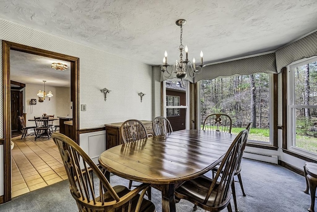 tiled dining space featuring a textured ceiling, wallpapered walls, an inviting chandelier, and baseboard heating