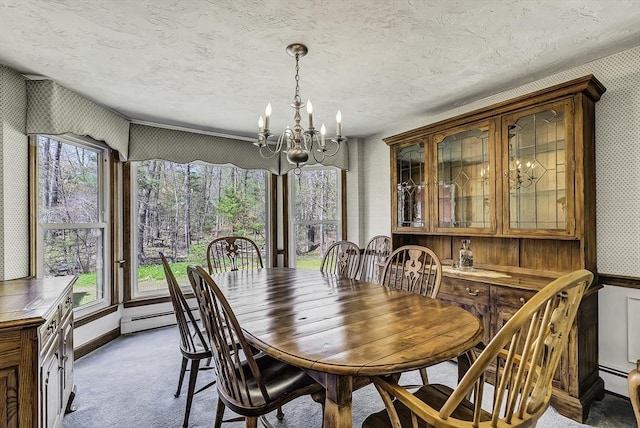 dining area with light colored carpet, wallpapered walls, a notable chandelier, and baseboard heating