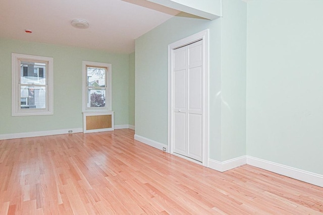 unfurnished bedroom featuring light hardwood / wood-style floors and a closet