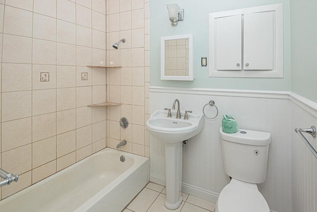 full bathroom featuring tile patterned floors, sink, tiled shower / bath combo, and toilet