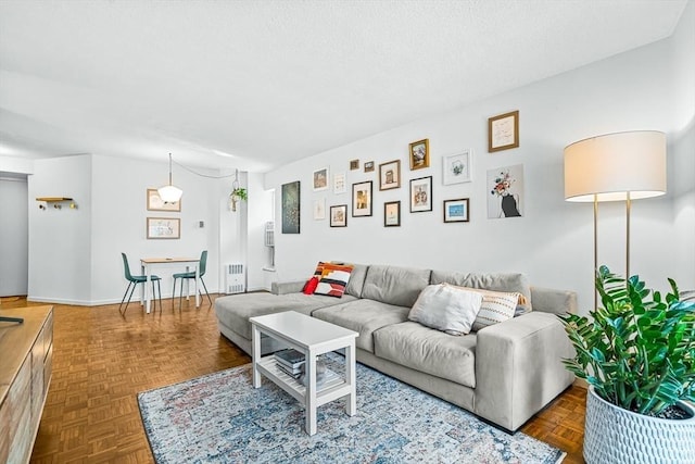 19 Winchester St Unit 102, Brookline, MA 02446 - living area featuring radiator heating unit and a textured ceiling
