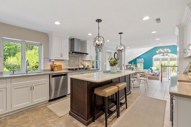 134 Reed Farm Rd, Boxborough, MA 01719 - kitchen featuring stainless steel appliances, wall chimney exhaust hood, a chandelier, a sink, and white cabinets