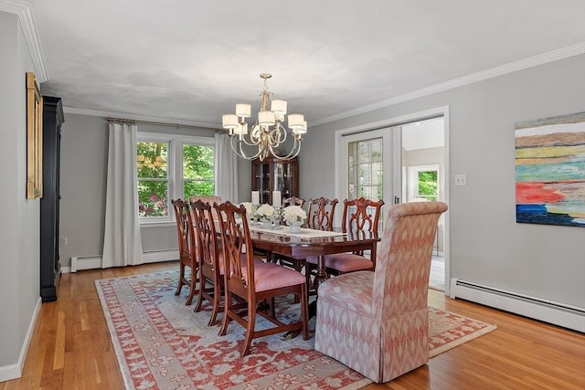 134 Reed Farm Rd, Boxborough, MA 01719 - dining area with a chandelier, crown molding, light wood-style flooring, a baseboard radiator, and baseboards