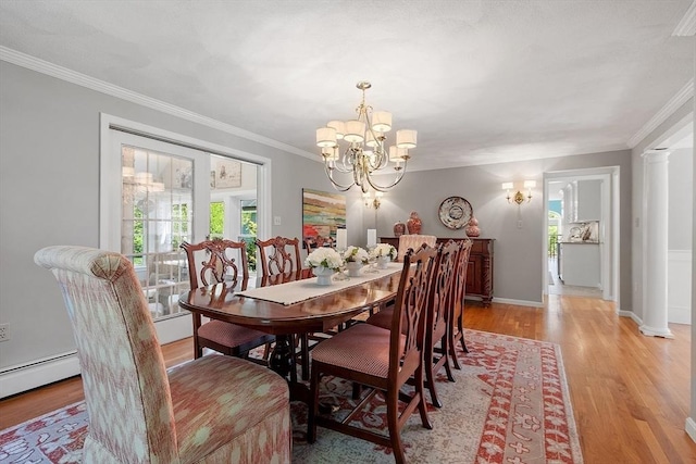 134 Reed Farm Rd, Boxborough, MA 01719 - dining area with light wood finished floors, a chandelier, ornamental molding, baseboard heating, and baseboards