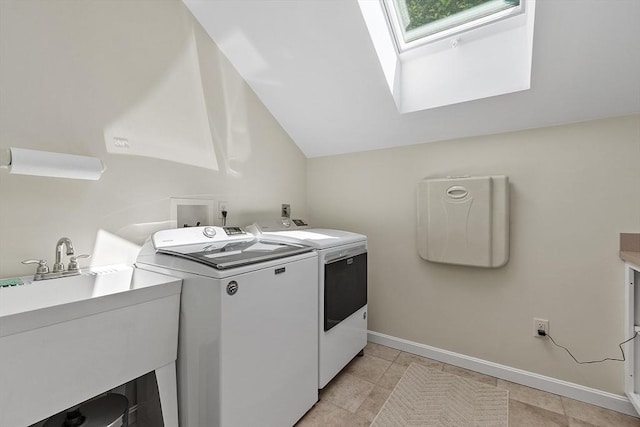 134 Reed Farm Rd, Boxborough, MA 01719 - laundry area featuring separate washer and dryer, a skylight, light tile patterned floors, and baseboards