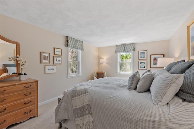 134 Reed Farm Rd, Boxborough, MA 01719 - bedroom with light colored carpet, multiple windows, and baseboards
